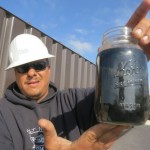 PHOTO BY MOSE BUCHELE The new black gold? Brian Schoonover works for Water Rescue Services, a group that treats brackish and "produced" water so it can be used in hydraulic fracturing. Here he holds a mason jar of produced water, ready for treatment.